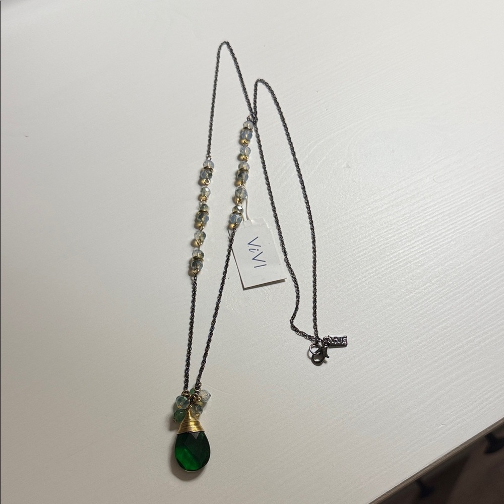 ViVi brand necklace with a green tear-drop pendant and beaded accents